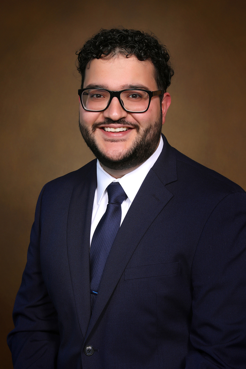 Ahmad Hider in a navy suit